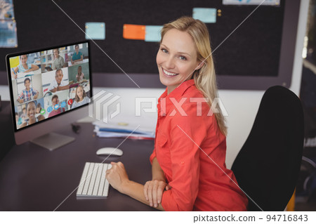Portrait of female teacher having a video conference with multiple students on computer at school Portrait of female teacher having a video conference with multiple students on computer at school 94716843