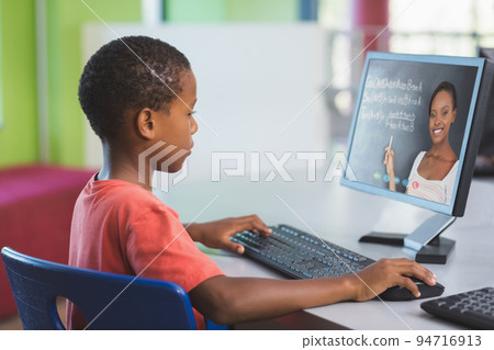 African american schoolboy using computer on video call with female teacher African american schoolboy using computer on video call with female teacher 94716913