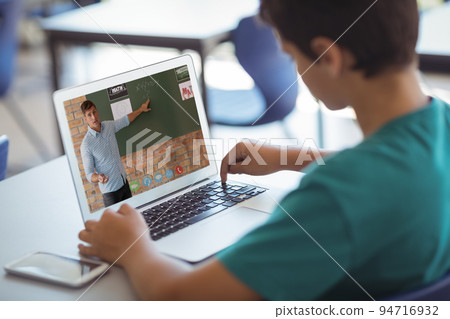 Caucasian schoolboy using laptop on video call with male teacher Caucasian schoolboy using laptop on video call with male teacher 94716932