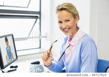 Portrait of female caucasian teacher having a video call with male student on computer at school Portrait of female caucasian teacher having a video call with male student on computer at school 94717028