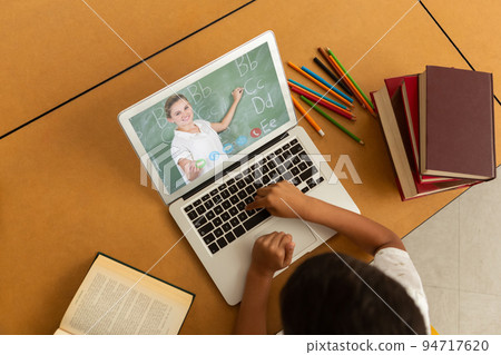 Mixed race schoolboy using laptop on video call with female teacher Mixed race schoolboy using laptop on video call with female teacher 94717620