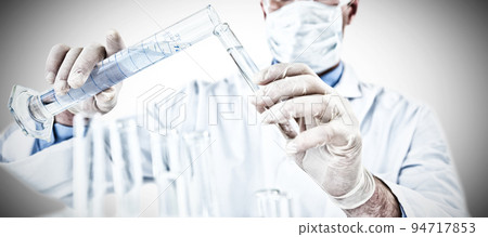 Doctor wearing medical gloves filling the test tube. Testing for Coronavirus pandemic 94717853