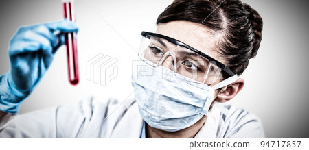 Female scientist holding test tube. Testing for Coronavirus pandemic 94717857
