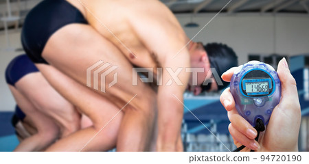 Composite image of close up of a hand holding a timer on a white background Composite image of close up of a hand holding a timer on a white background 94720190