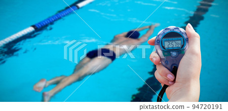 Composite image of close-up of a woman holding a chronometer to measure performance 94720191