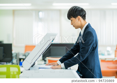 A man in general affairs taking a copy A man in general affairs taking a copy 94720869