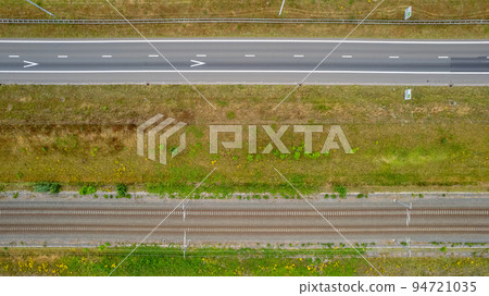 Aerial view of highway road junction. Highways, bridge and green fields on the outskirts of the city 94721035