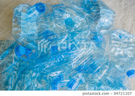 Large stack of old plastic bottles on the floor 94721107