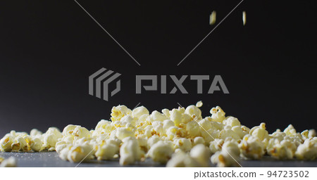 Image of close up of popcorn falling on black background 94723502