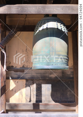 Temple bell reflecting in bright light 94724094