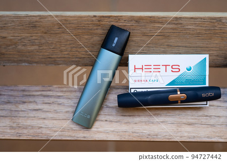 Tarragona, Spain - September 16, 2022: Electronic cigarettes IQOS close-up. Different options for smoking and cigarette. Choice of devices for the use of nicotine. 94727442