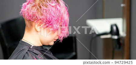 Beautiful young pink haired caucasian woman in the modern hair salon Beautiful young pink haired caucasian woman in the modern hair salon 94729425