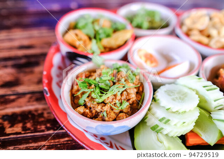 Northern traditional thai food set called "Kantoke Dinner" consist of crispy pork,tomato paste, mix vegetable,mince pork, chilli paste, sausage Northern traditional thai food set called "Kantoke Dinner" consist of crispy pork,tomato paste, mix vegetable,mince pork, chilli paste, sausage 94729519