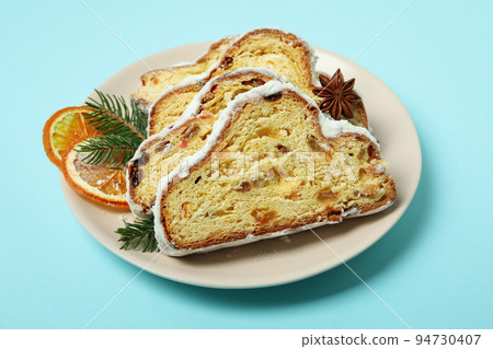 Concept of German dessert - Stollen on blue background Concept of German dessert - Stollen on blue background 94730407