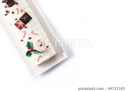 White chocolate yule log cake with ornament isolated on white background White chocolate yule log cake with ornament isolated on white background 94731165