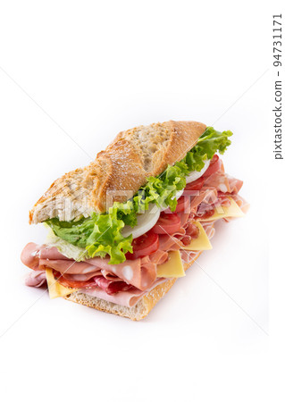 Submarine sandwich with ham, cheese, lettuce, tomatoes,onion, mortadella and sausage isolated on white background Submarine sandwich with ham, cheese, lettuce, tomatoes,onion, mortadella and sausage isolated on white background 94731171