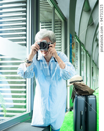 Portrait of happy senior adult elderly asia woman 60s taking pictures with photo camera for travel concept. Portrait of happy senior adult elderly asia woman 60s taking pictures with photo camera for travel concept. 94731525