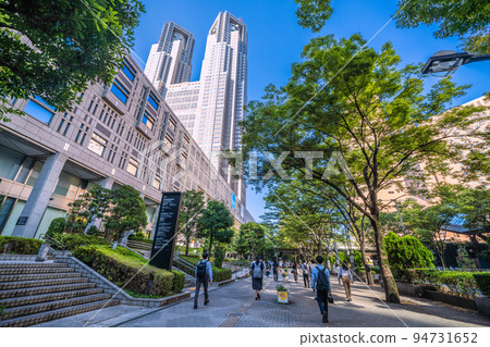Tokyo cityscape in Japan Shinjuku subcenter, morning commute (mostly from Shinjuku station) scenery. Tokyo Metropolitan Government Office on the left = September 26 94731652