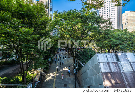 Tokyo cityscape in Japan Shinjuku subcenter, morning commute (mostly from Shinjuku station) scenery. Tokyo Metropolitan Government Office on the left = September 26 94731653