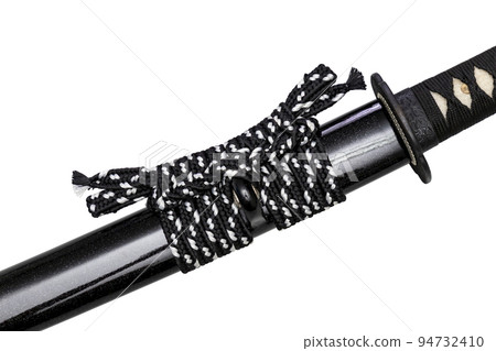 Close up shot of Sageo - Thick black-white silk rope for tying the scabbard of Japanese swords. It was a rope for the samurai to tie at the waist. isolated on white background. Selective focus. Close up shot of Sageo - Thick black-white silk rope for tying the scabbard of Japanese swords. It was a rope for the samurai to tie at the waist. isolated on white background. Selective focus. 94732410
