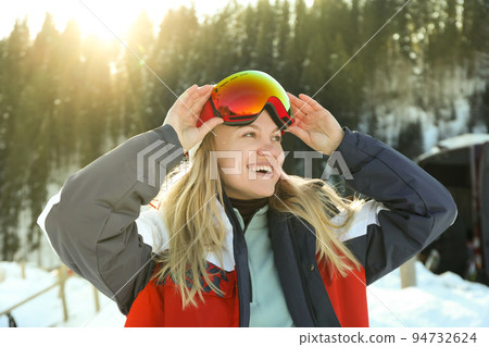 Attractive young woman skier in mountain resort Attractive young woman skier in mountain resort 94732624