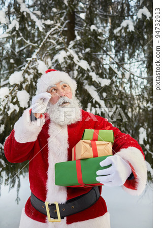 Santa With Stack of Presents Outdoors Santa With Stack of Presents Outdoors 94732913
