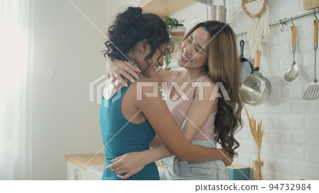 Holiday concept of 4k Resolution. Asian women embracing each other in the kitchen. Young women are in a mutual lesbian love relationship. 94732984