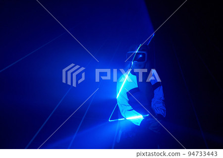 Woman is using virtual reality headset to access in metaverse. Woman is using virtual reality headset to access in metaverse. 94733443