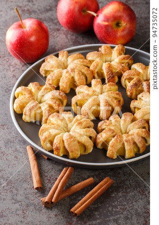 Autumn apples baked in dough close-up on a plate. Vertical 94735072