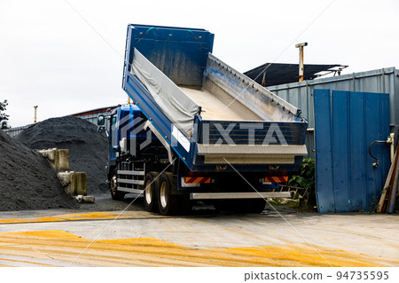 A large dump truck that transports crushed stone for building materials A large dump truck that transports crushed stone for building materials 94735595