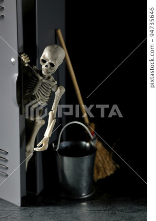 A skeleton coming out of a cleaning locker 94735646
