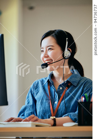 在辦公室接電話的年輕女人 94736737