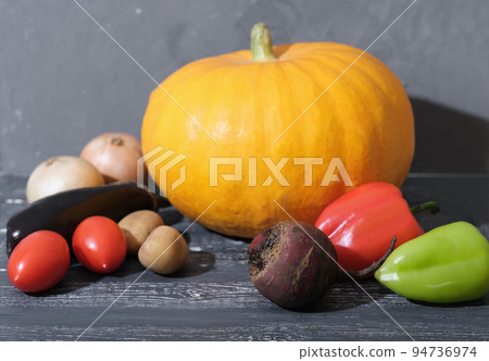 Autumn harvest organic pumpkin vegetables. garden grown Vegetables or farm cultivated. Homegrown vegetables. Fresh organic veggies on dark wooden table. Autumn harvest organic pumpkin vegetables. garden grown Vegetables or farm cultivated. Homegrown vegetables. Fresh organic veggies on dark wooden table. 94736974