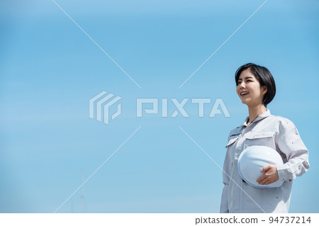 Young female site foreman with helmet Young female site foreman with helmet 94737214