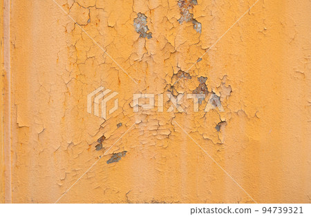 Old rusty orange plaque for the background, rust damages old plaque wall, old rusty orange old plaque and corrosion over a wide area of steel plate surface. 94739321
