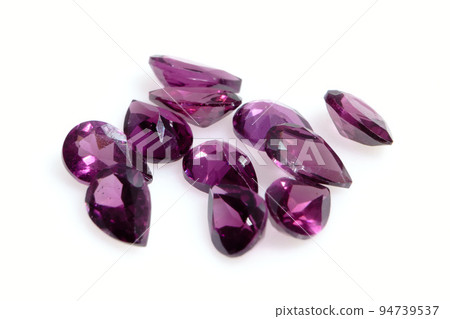 Natural gemstone pink rhodolite garnet on gray background 94739537