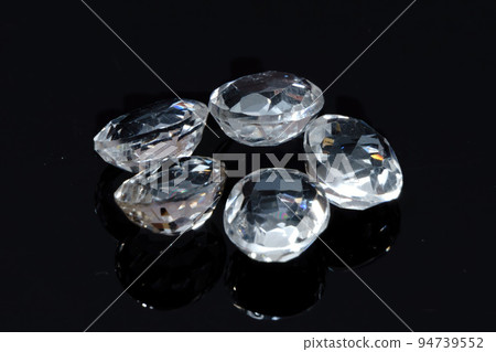Natural gemstone white topaz on black background Natural gemstone white topaz on black background 94739552