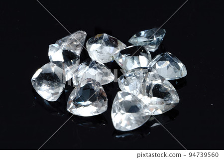 Natural gemstone white topaz on black background Natural gemstone white topaz on black background 94739560