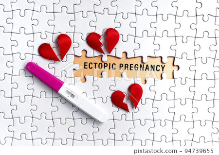 White jigsaw puzzle with ectopic pregnancy word over orange background. White jigsaw puzzle with ectopic pregnancy word over orange background. 94739655