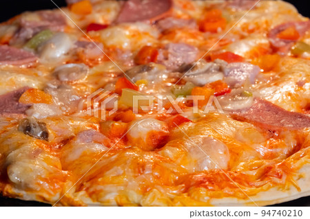 Baked homemade pizza in electric oven at home: close up 94740210