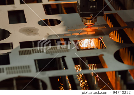 Laser cutting machine working with sheet metal with sparks Laser cutting machine working with sheet metal with sparks 94740232