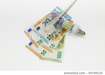 Electric plug, light bulb, and euro banknotes. Concept of rise in energy bill prices 94740520