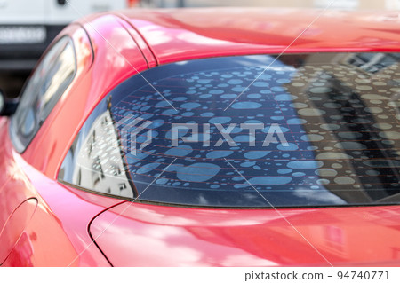 Rear car window with old adhesive defective dark sunproof tint film in air bubbles. Mistake wrong badly installation tinting vehicle service maintenance Rear car window with old adhesive defective dark sunproof tint film in air bubbles. Mistake wrong badly installation tinting vehicle service maintenance 94740771