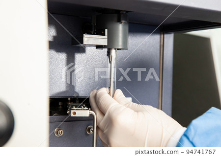 Scientist loading a test tube containing a patient sample on the flow cytometer for analysis. Flow cytometer Scientist loading a test tube containing a patient sample on the flow cytometer for analysis. Flow cytometer 94741767