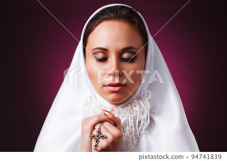 Nice girl dressed as a nun on a black background 94741839