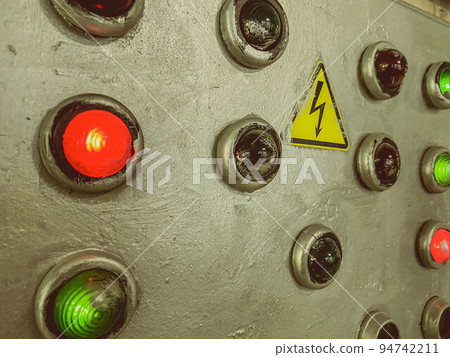 control buttons on the electrical panel. the power indicators glow red or green when energized. remote control panel. installed sign under big electricity. buttons on gray painted material control buttons on the electrical panel. the power indicators glow red or green when energized. remote control panel. installed sign under big electricity. buttons on gray painted material 94742211