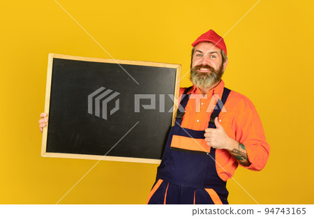 Man worker hold chalkboard copy space. Electrician plumber handyman. Repairman worker. Construction worker. Fixing technics. Housekeeping company. Services we offer. Mechanic perform technical work 94743165