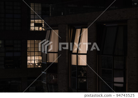 Modern office building at night in New York City 94743525