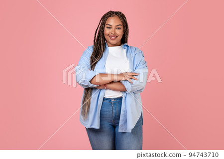 Smiling Overweight Lady Standing In Studio On Pink Background Smiling Overweight Lady Standing In Studio On Pink Background 94743710