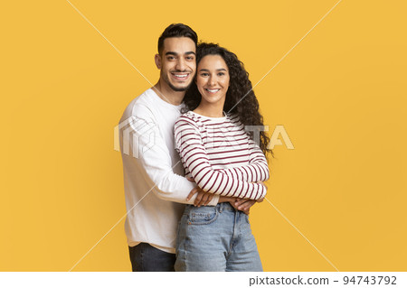 Portrait Of Loving Arab Man And Woman Embracing And Smiling At Camera 94743792
